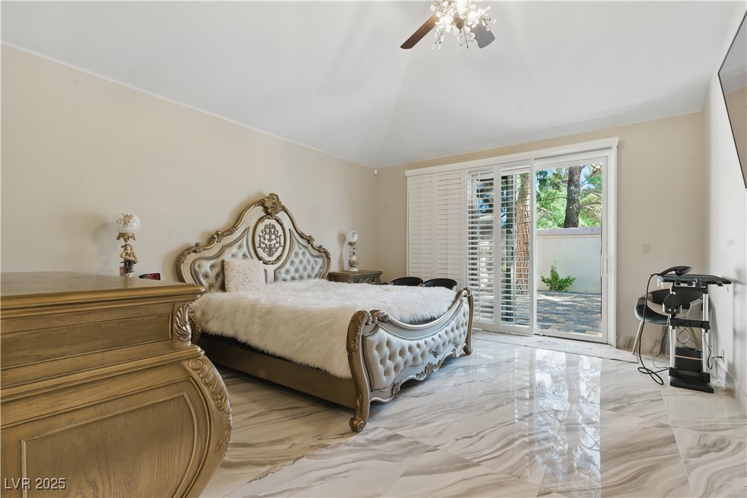 8215 Crow Valley Lane Las Vegas, NV 89113 - Photo 29 of 43 Bedroom with access to exterior, light marble finish flooring, and a ceiling fan