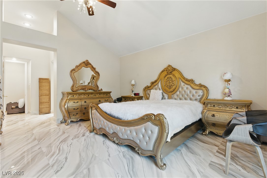 8215 Crow Valley Lane Las Vegas, NV 89113 - Photo 30 of 43 Bedroom with a ceiling fan and high vaulted ceiling