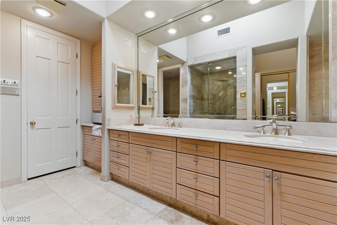 8215 Crow Valley Lane Las Vegas, NV 89113 - Photo 31 of 43 Full bathroom featuring double vanity, a shower stall, light tile patterned floors, and recessed lighting