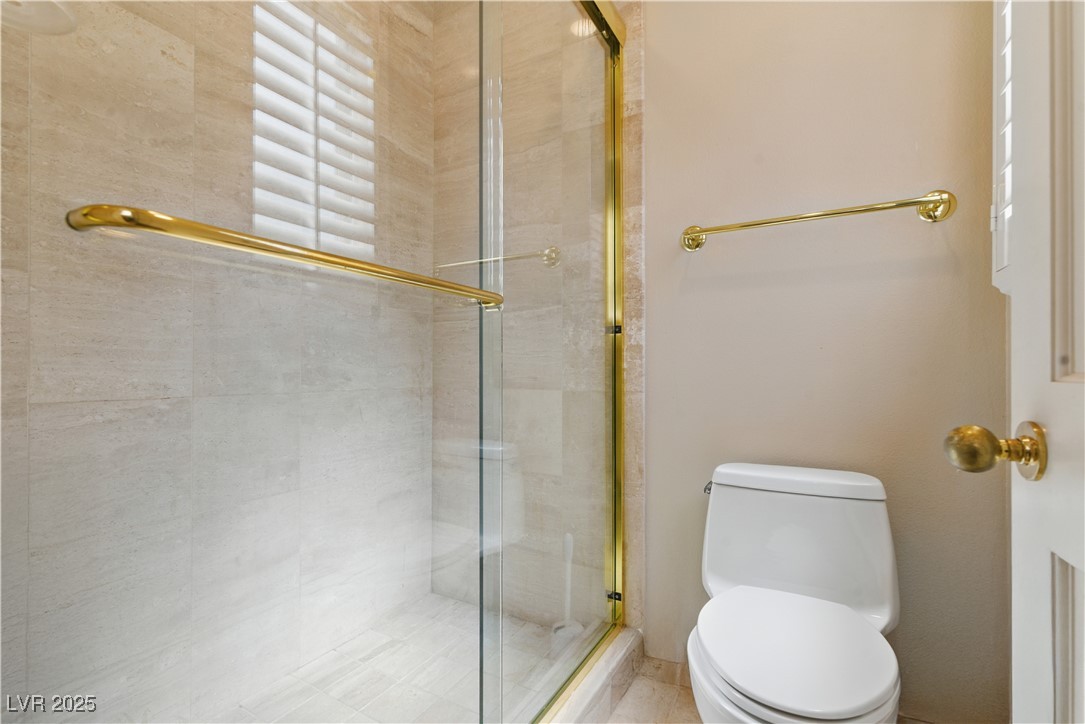 8215 Crow Valley Lane Las Vegas, NV 89113 - Photo 36 of 43 Full bathroom with a stall shower and toilet