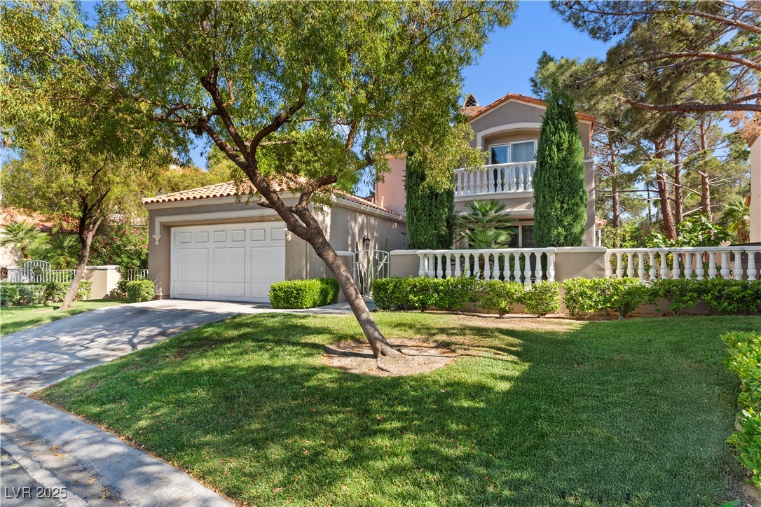 8215 Crow Valley Lane Las Vegas, NV 89113 - Photo 7 of 43 Mediterranean / spanish home with a tile roof, stucco siding, driveway, and a balcony