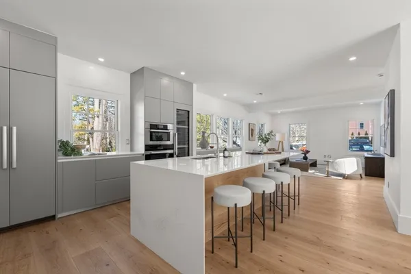 a kitchen with sink table and chairs
