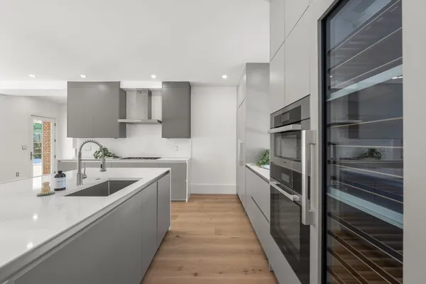 a kitchen with kitchen island granite countertop a sink and stainless steel appliances