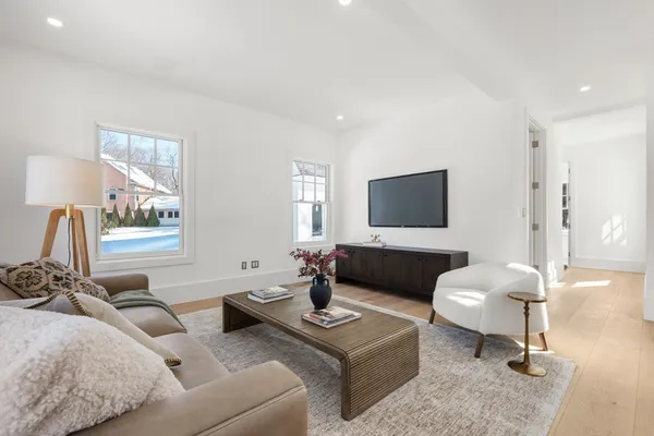 a living room with furniture a lamp and a flat screen tv