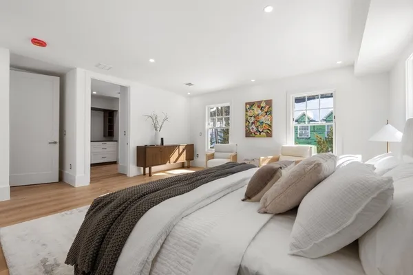 a bedroom with a bed and a large window