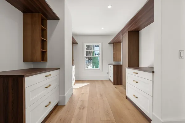 wooden floor with white cabinets and wooden floor