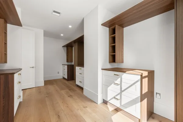 a view of hallway with stairs and wooden floor