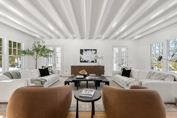 a living room with furniture a rug and a chandelier