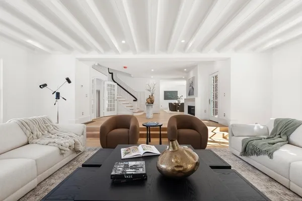 a living room with furniture and gym equipment