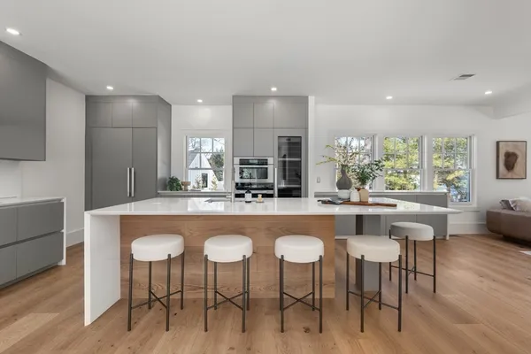 a kitchen with granite countertop a table and chairs in it