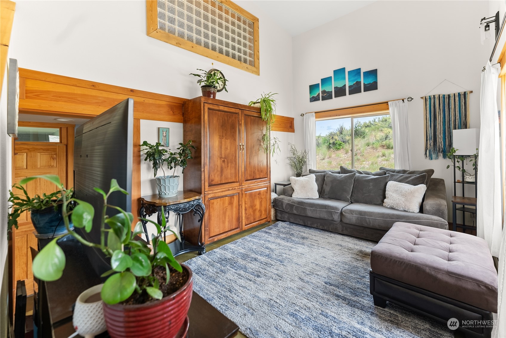 33 West Chewuch Road Winthrop, WA 98862 - Photo 8 of 33 a living room with furniture a potted plant and a large window