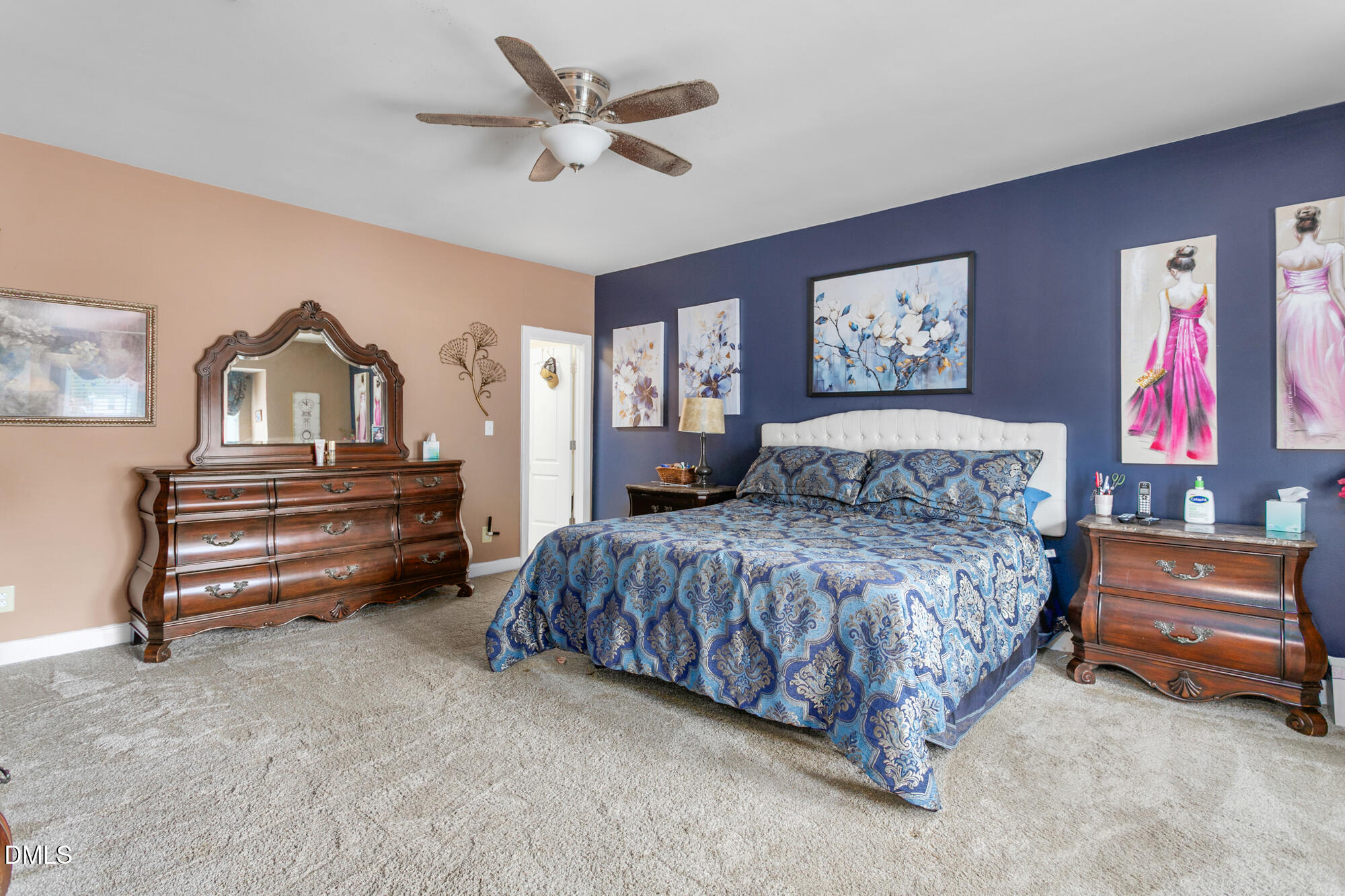 3163 Saul Loop Road Elon, NC 27244 - Photo 19 of 44 a bedroom with a bed and a chandelier