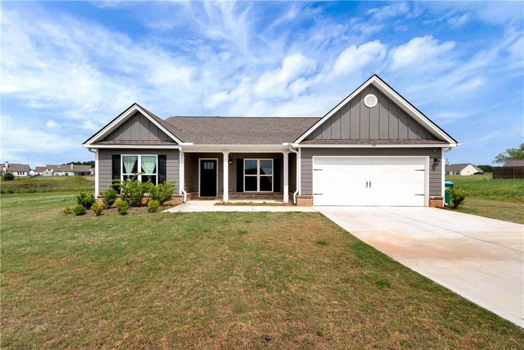 147 Shallow Way Winder, GA 30680 - Photo 1 of 1 a front view of a house with a yard and garage