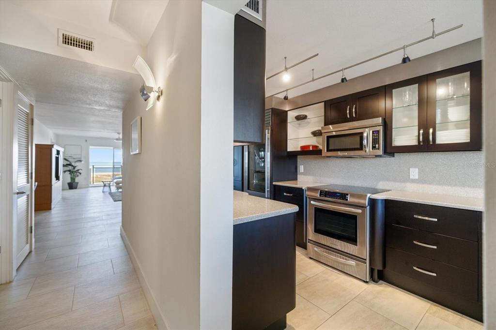625 Beach Road, Unit 602 Sarasota, FL 34242 - Photo 14 of 65 a kitchen with stainless steel appliances granite countertop a refrigerator and a stove