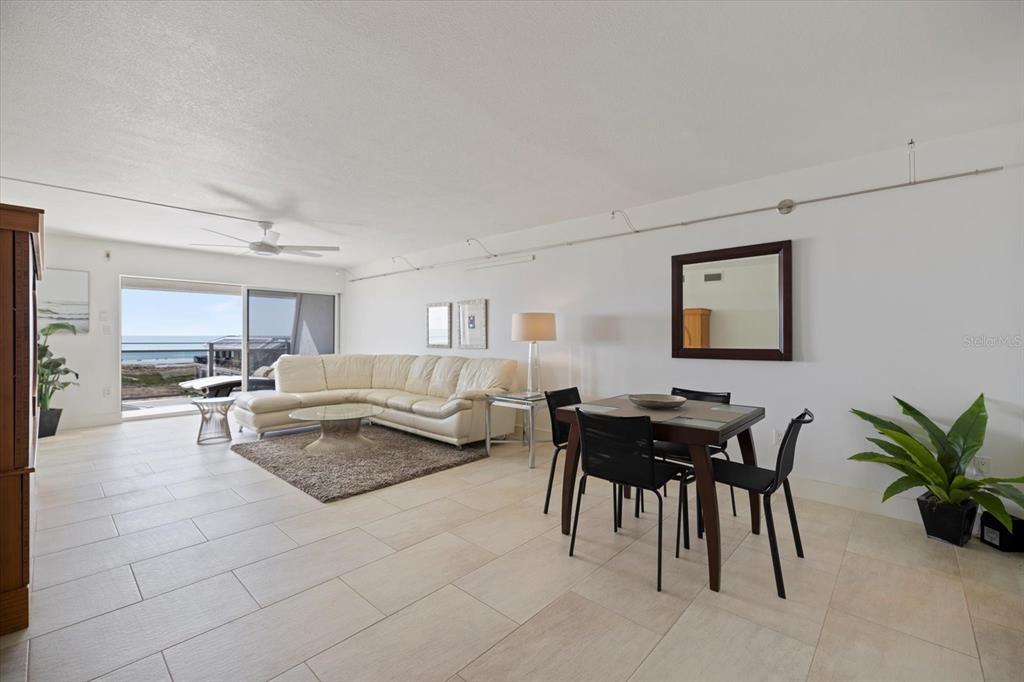 625 Beach Road, Unit 602 Sarasota, FL 34242 - Photo 17 of 65 a living room with furniture and a dining table with potted plants
