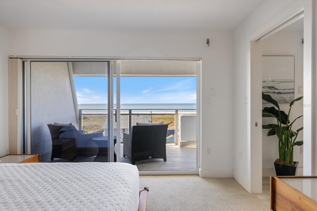 625 Beach Road, Unit 602 Sarasota, FL 34242 - Photo 22 of 65 a bedroom with a balcony a bed and a table