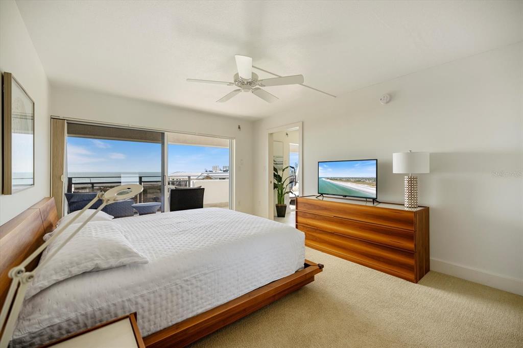 625 Beach Road, Unit 602 Sarasota, FL 34242 - Photo 24 of 65 a bedroom with a bed dresser and wooden floor