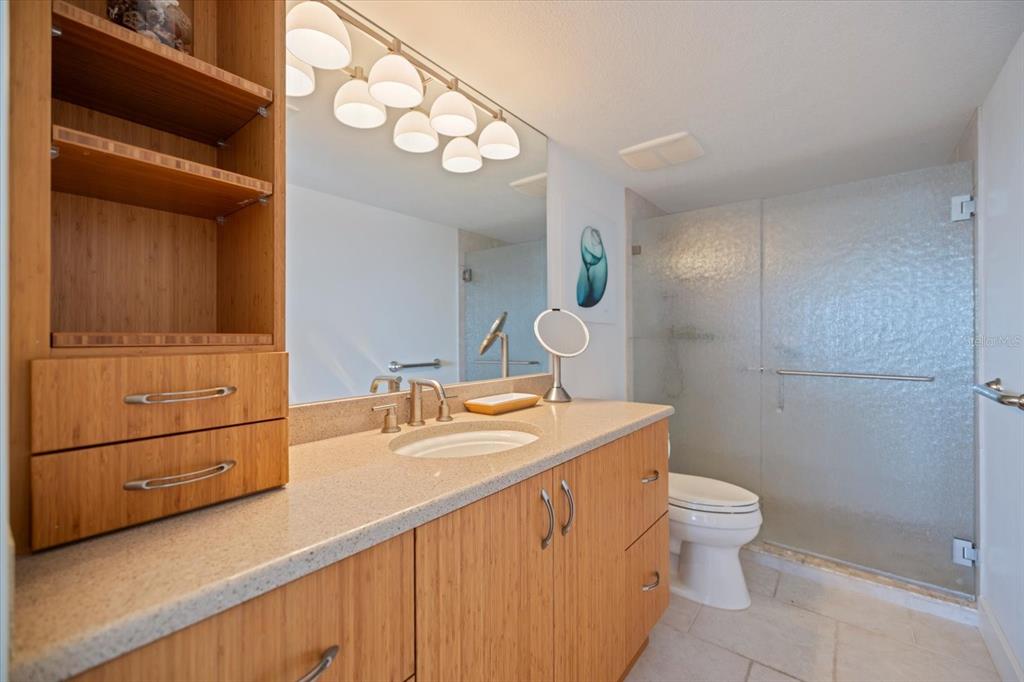 625 Beach Road, Unit 602 Sarasota, FL 34242 - Photo 27 of 65 a bathroom with a sink a toilet and shower