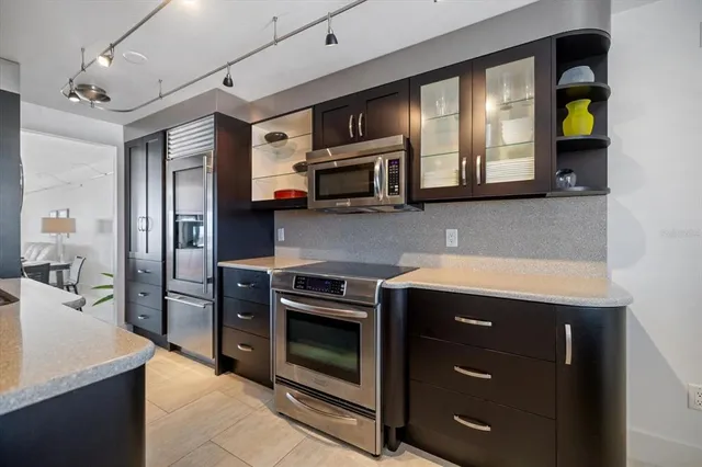 a living room with furniture white walls and a refrigerator