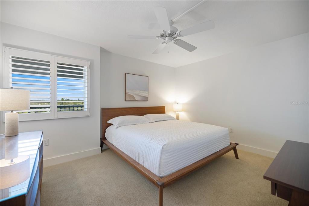 625 Beach Road, Unit 602 Sarasota, FL 34242 - Photo 31 of 65 a bedroom with a bed and a night stand