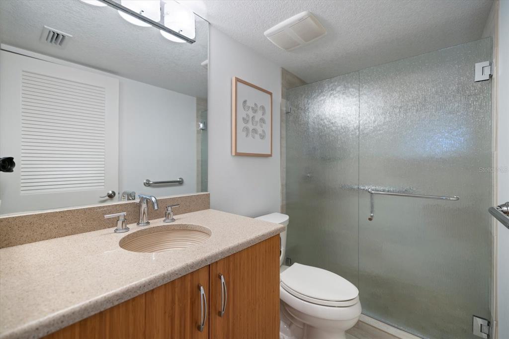 625 Beach Road, Unit 602 Sarasota, FL 34242 - Photo 33 of 65 a bathroom with a granite countertop sink toilet and a mirror