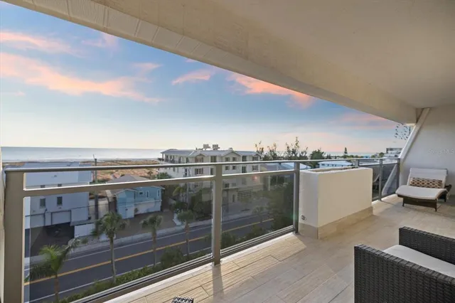 a view of a balcony with furniture and city view