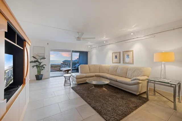 a view of a city from a balcony with furniture