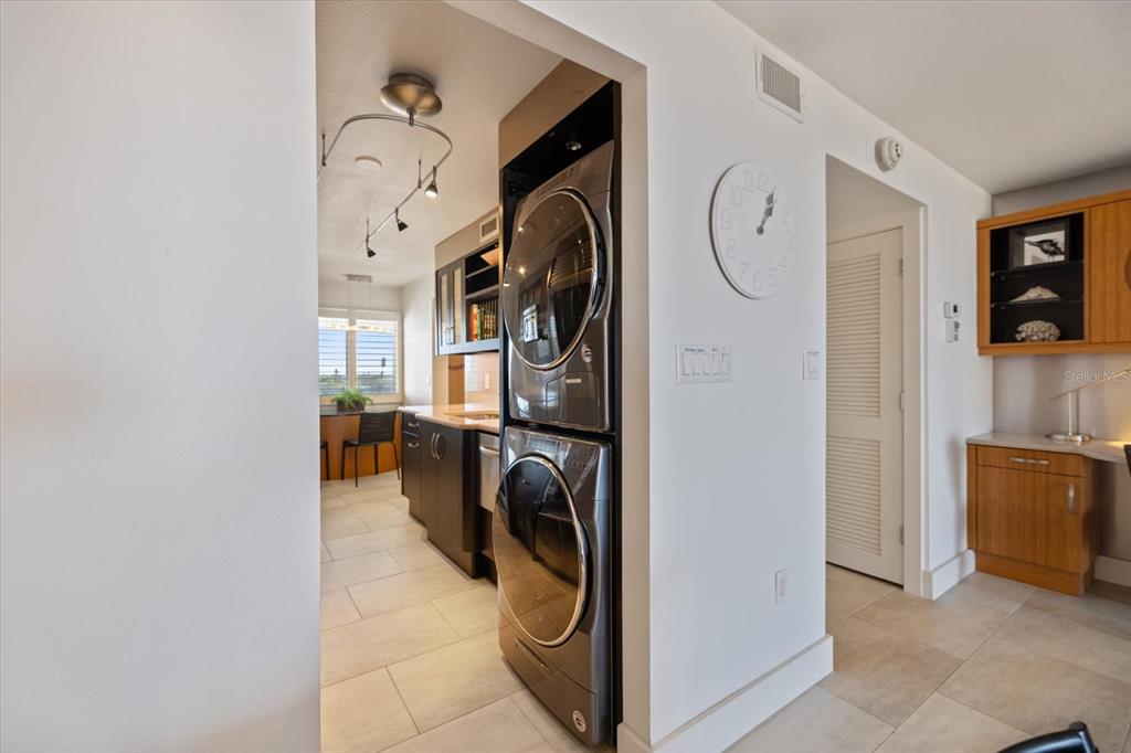 625 Beach Road, Unit 602 Sarasota, FL 34242 - Photo 64 of 65 a view of walk in closet with clothes and washer