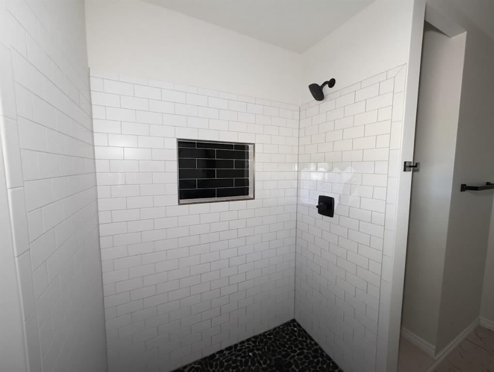 1512 West Day Street Denison, TX 75020 - Photo 11 of 14 a bathroom with a shower