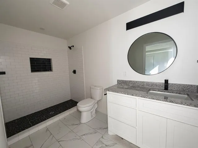 an empty room with a window and a ceiling fan