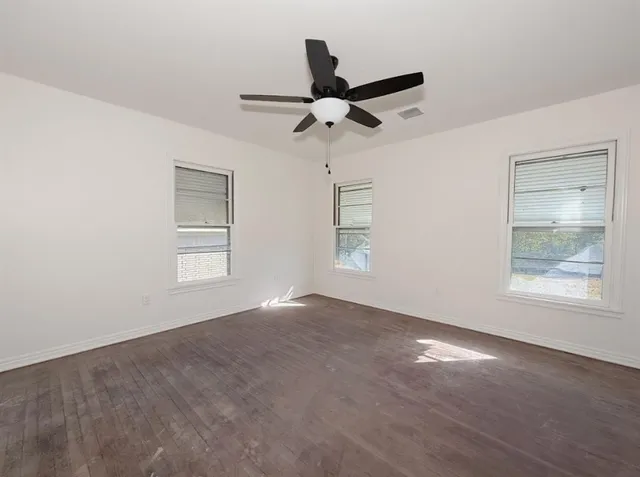 a bathroom with a granite countertop toilet a sink and mirror