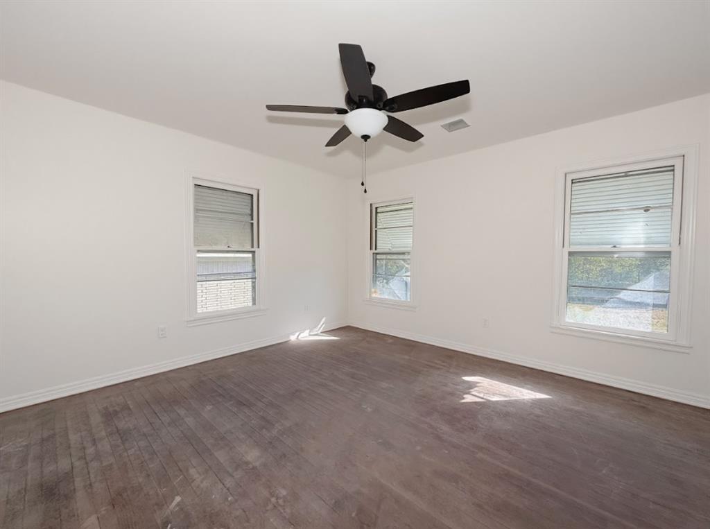 1512 West Day Street Denison, TX 75020 - Photo 9 of 14 a view of an empty room with a window