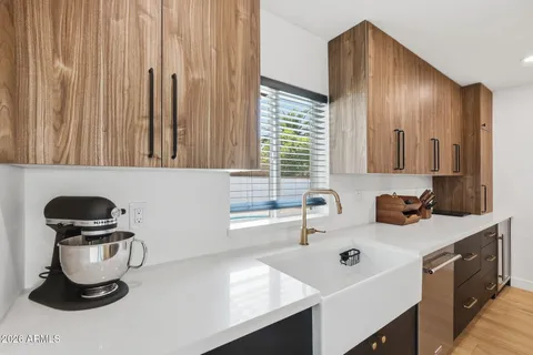 a open kitchen with stainless steel appliances granite countertop a stove and a refrigerator