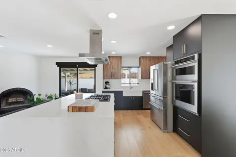a kitchen with a sink and a stove top oven