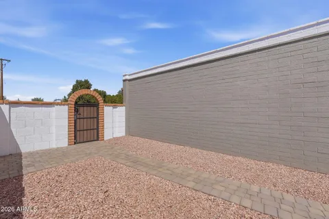 a view of a house with swimming pool and sitting area