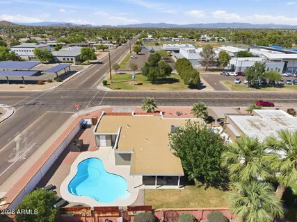 an aerial view of a house with a yard and a fountain