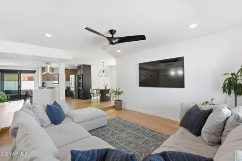 a living room with furniture and kitchen view