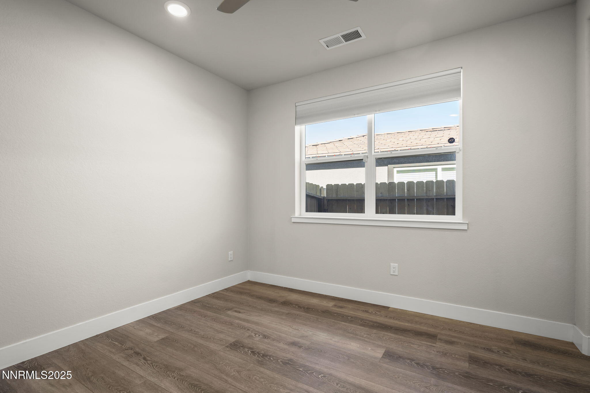7726 Enclave Key Road Reno, NV 89506 - Photo 15 of 25 an empty room with wooden floor and windows