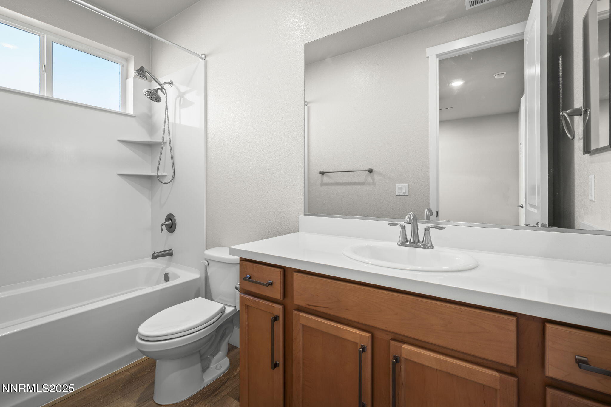 7726 Enclave Key Road Reno, NV 89506 - Photo 16 of 25 a bathroom with a granite countertop sink toilet and shower