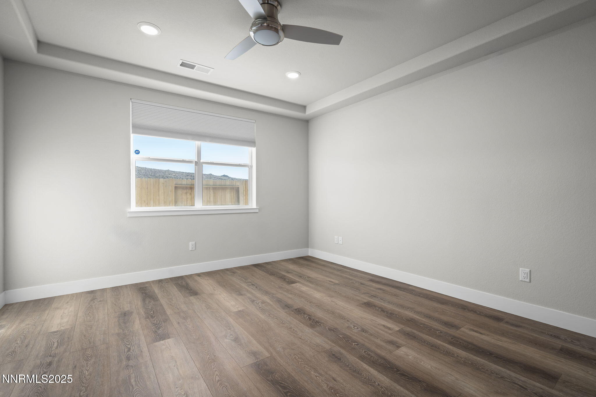 7726 Enclave Key Road Reno, NV 89506 - Photo 18 of 25 an empty room with a window and ceiling fan