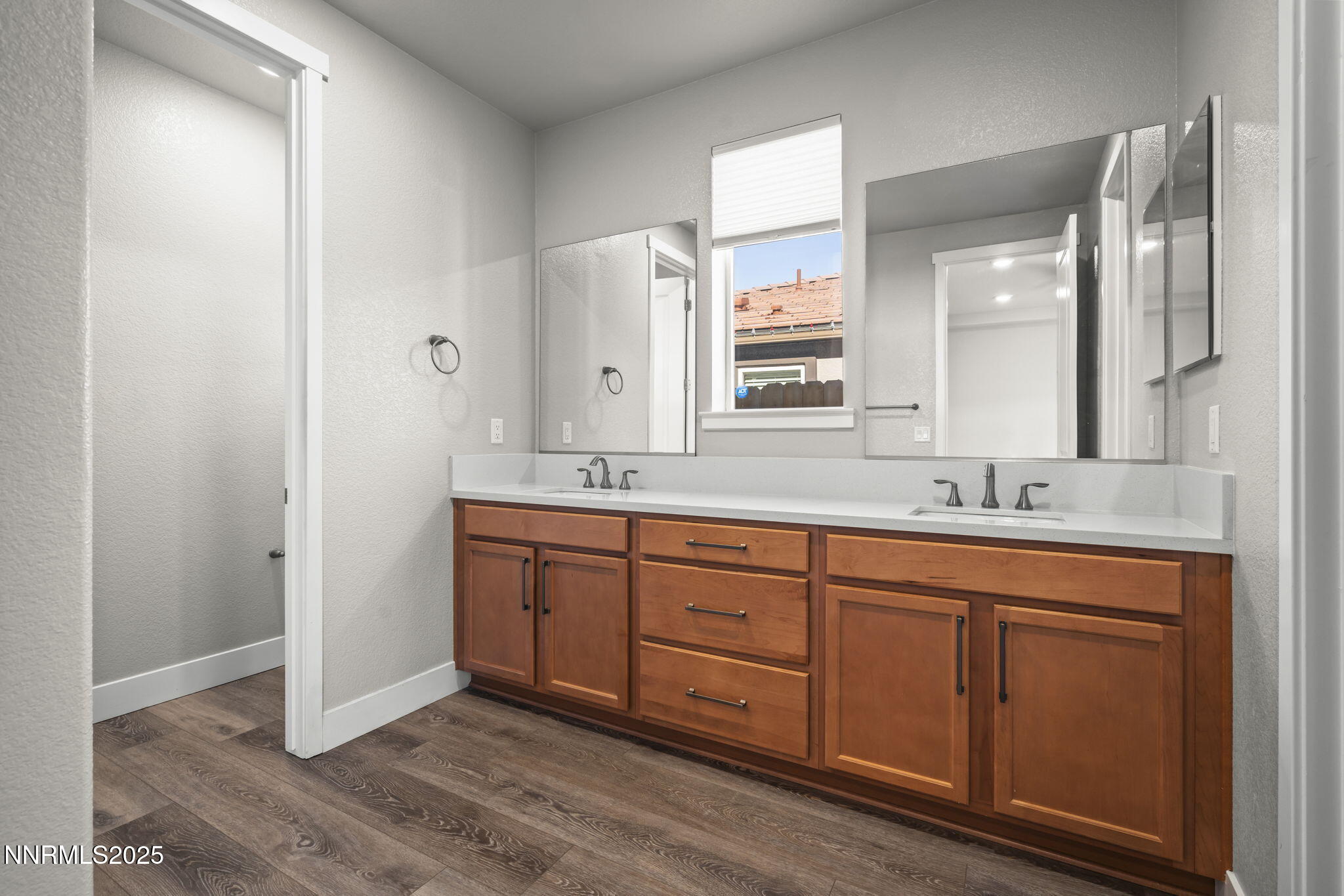 7726 Enclave Key Road Reno, NV 89506 - Photo 19 of 25 a spacious bathroom with a double vanity sink and a mirror