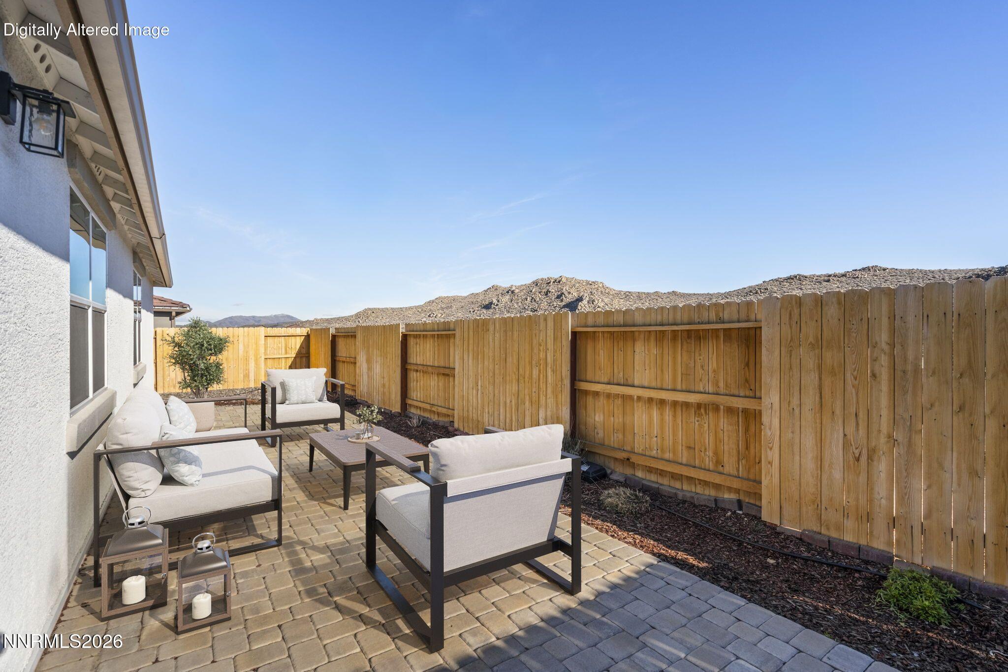 7726 Enclave Key Road Reno, NV 89506 - Photo 23 of 25 a view of a patio with couches chairs and wooden floor