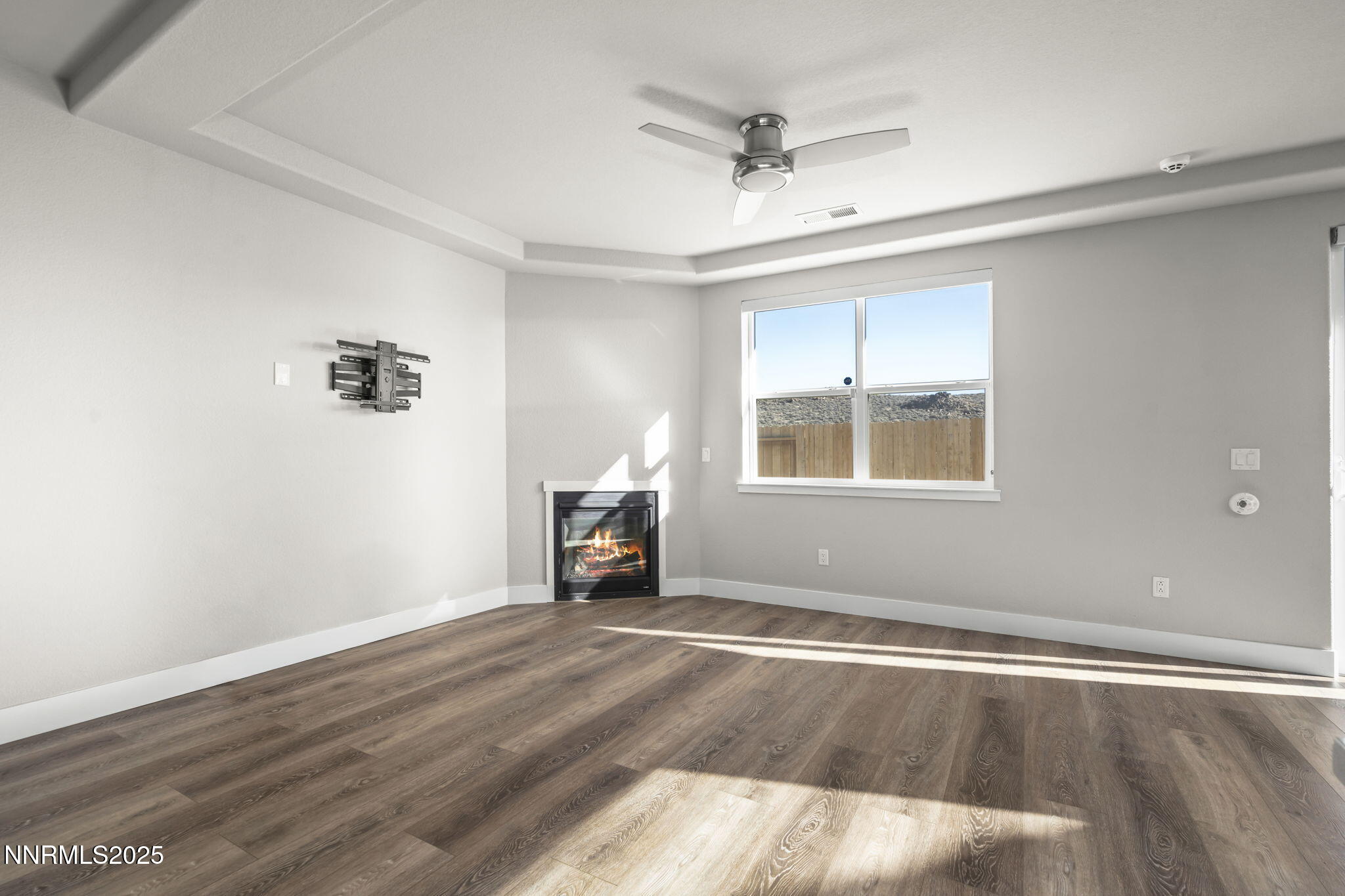 7726 Enclave Key Road Reno, NV 89506 - Photo 4 of 25 wooden floor in an empty room with a window
