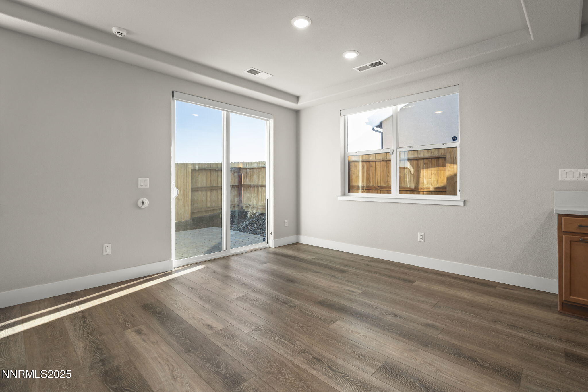 7726 Enclave Key Road Reno, NV 89506 - Photo 8 of 25 a view of an empty room with wooden floor and a window