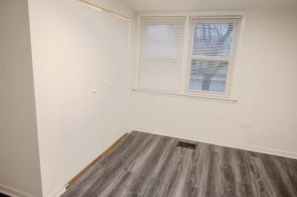 a view of a room with wooden floor and windows