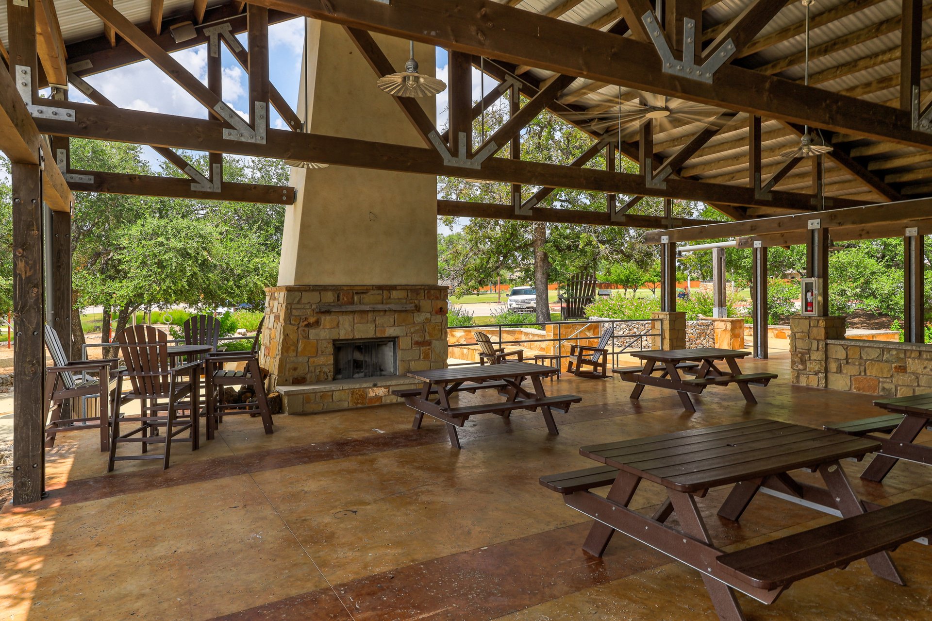 173 Santa Maria Street Georgetown, TX 78628 - Photo 36 of 39 Expansive covered outdoor pavilion featuring a stone-clad fireplace and exposed wood beam ceiling