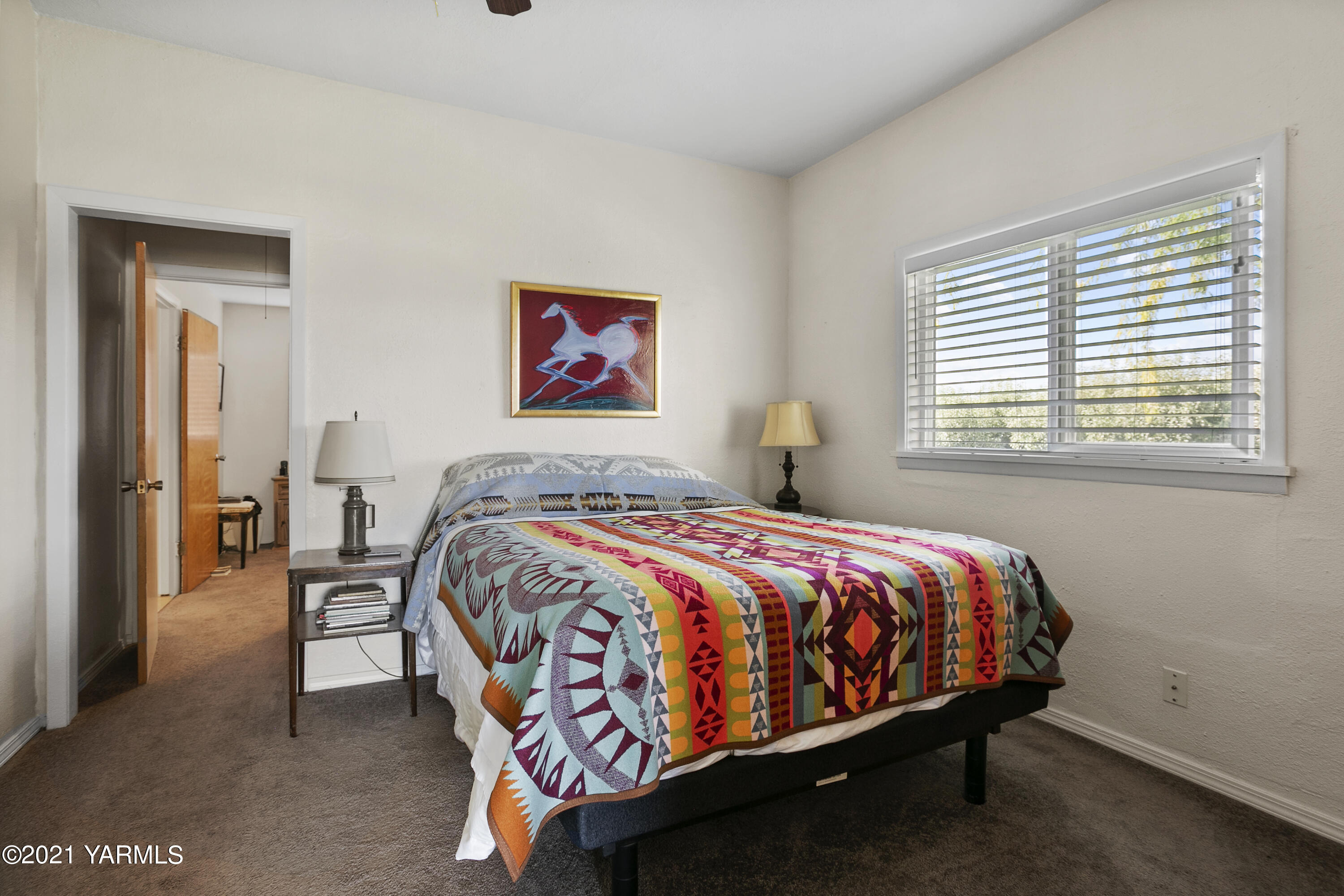 4171 Sheller Road Sunnyside, WA 98944 - Photo 11 of 28 a bed sitting in a bedroom next to a window
