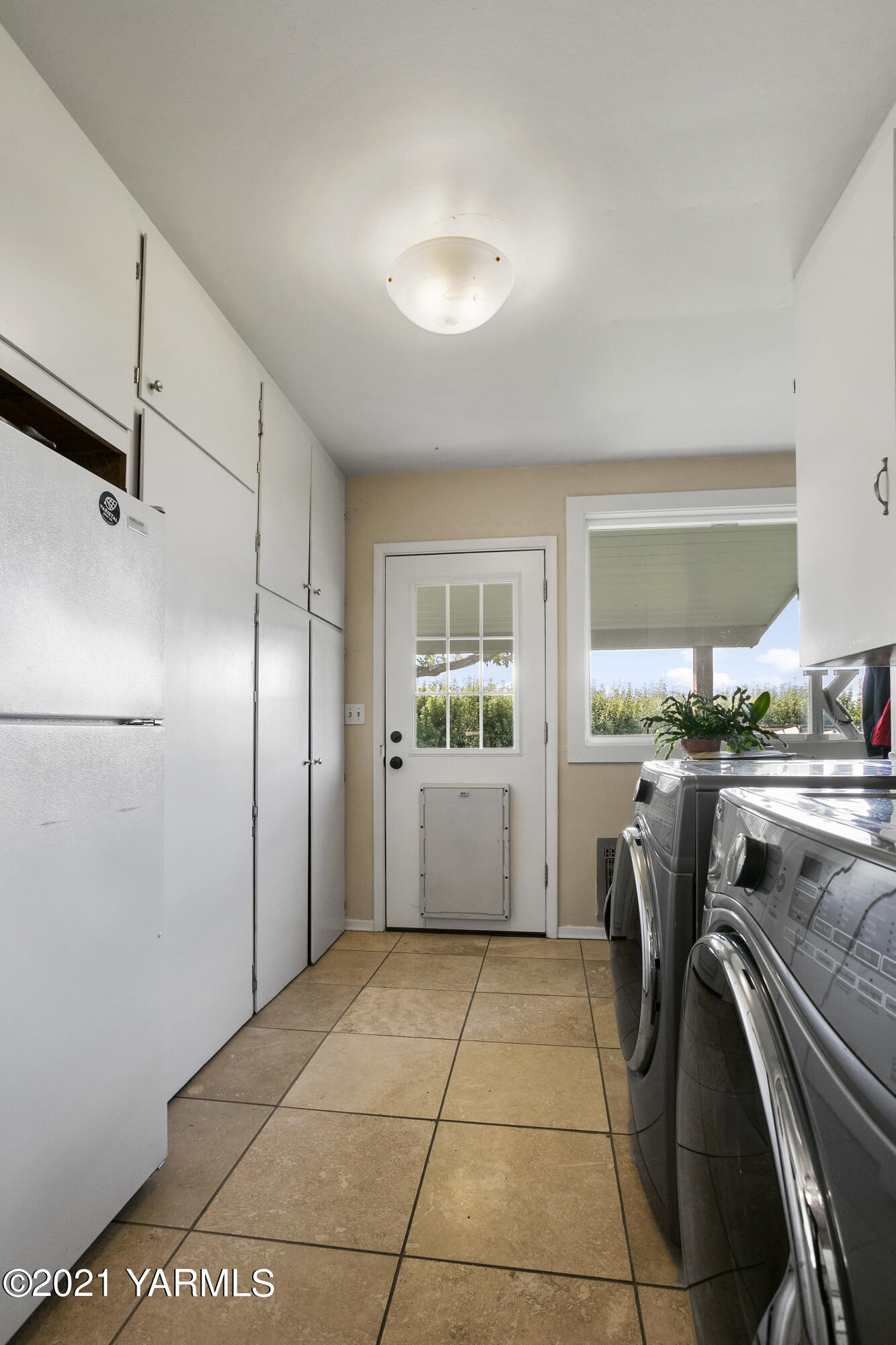 4171 Sheller Road Sunnyside, WA 98944 - Photo 15 of 28 a kitchen with a refrigerator and cabinets