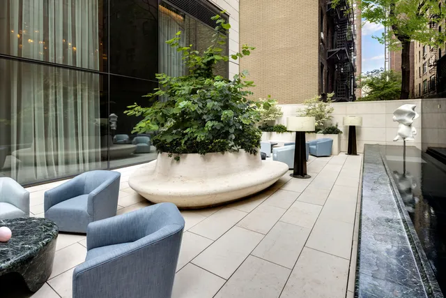 a view of a patio with couches and potted plants