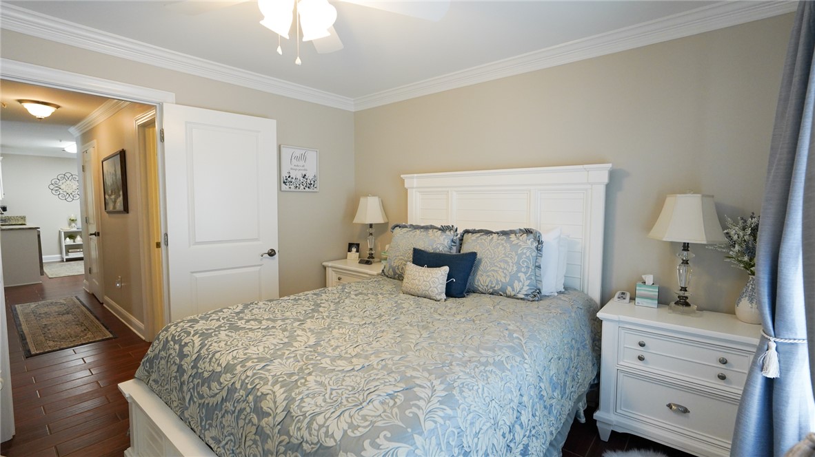 303 Lookover Drive Anderson, SC 29621 - Photo 23 of 46 This serene bedroom offers a restful retreat with elegant crown molding and rich hardwood flooring.